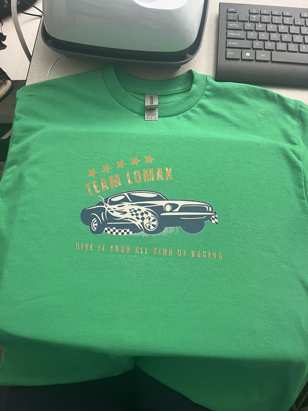 Green customer racing shirt with small lettering and a detailed car