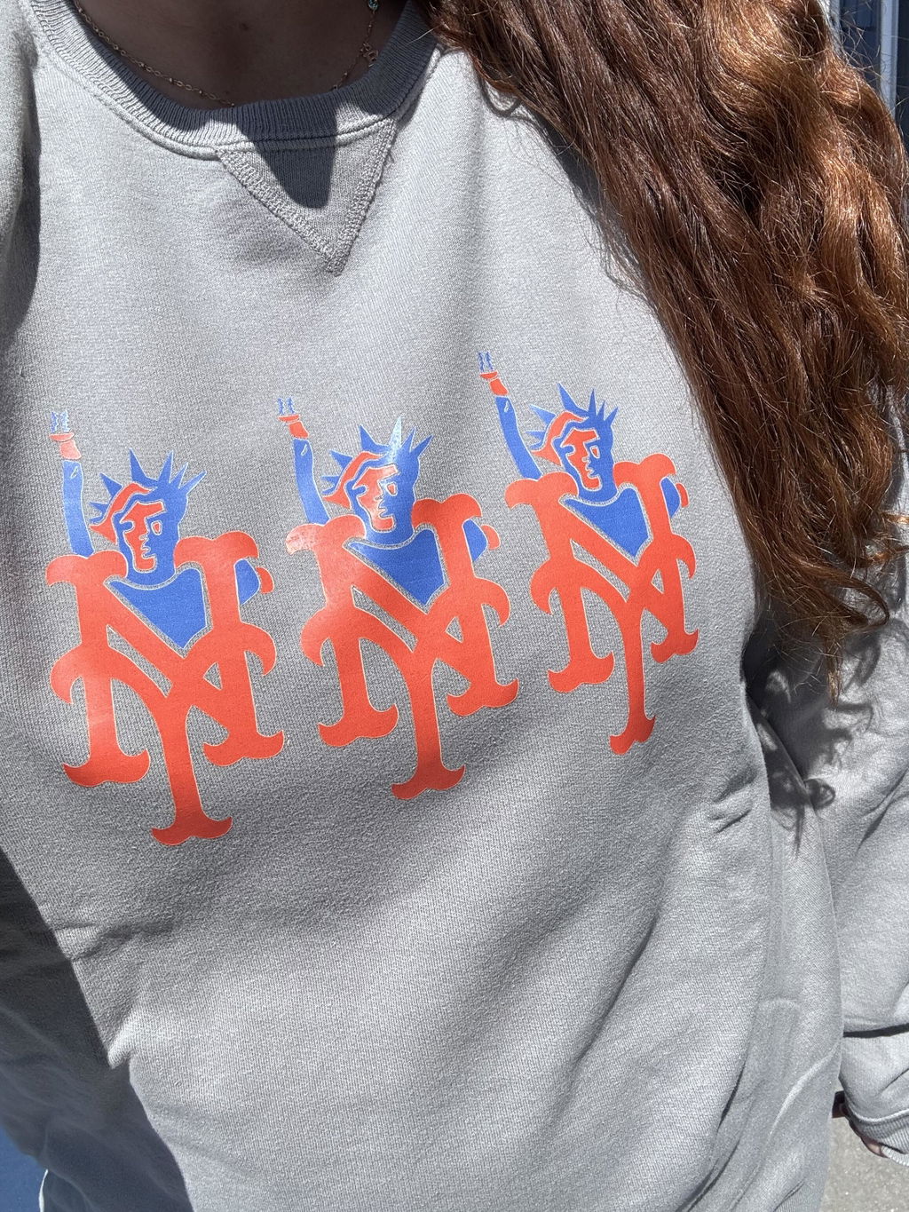 Bright orange and blue original artwork pressed on a gray shirt