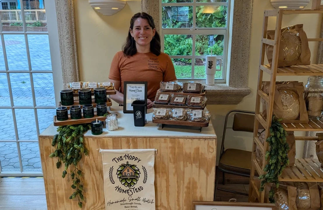 A DTFSheet customer behind a table of finished printed products