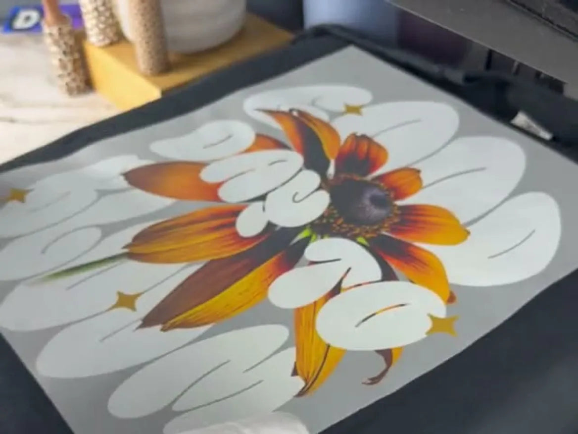 A flower transfer positioned on a heat press